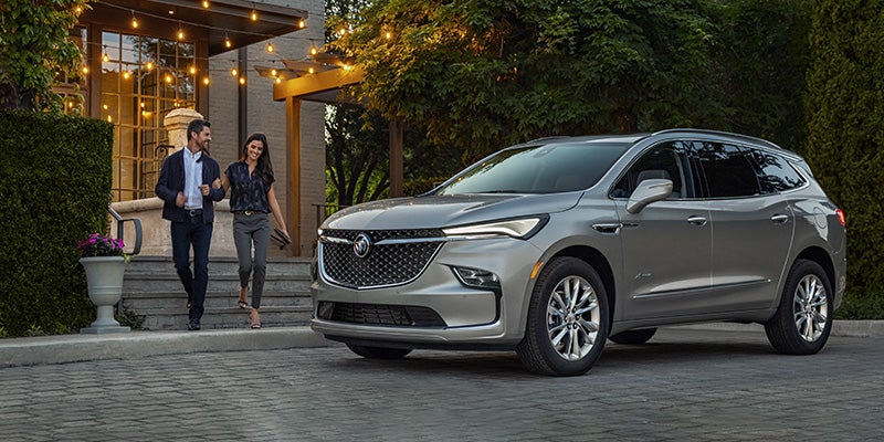 couple coming towards Buick Enclave