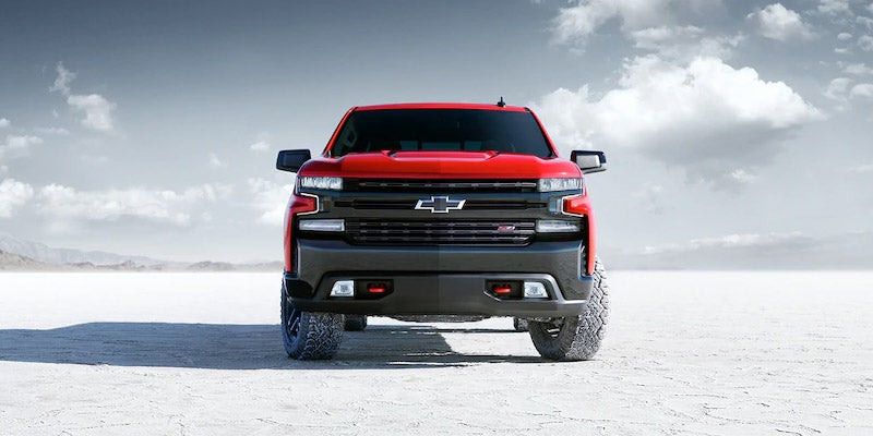 red Chevrolet Silverado 1500 on white dessert